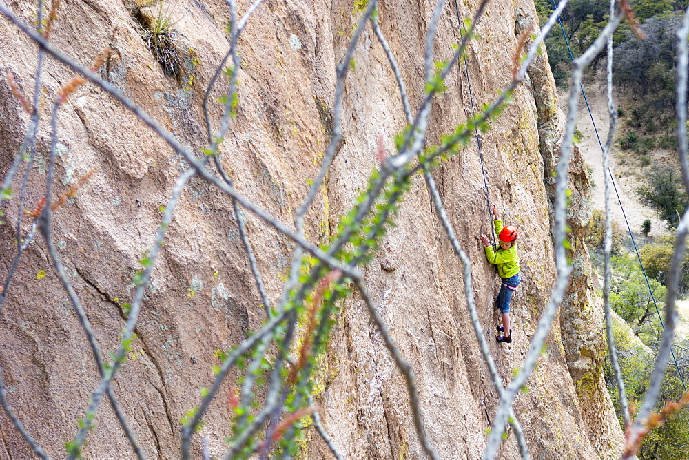 A girl rock being lowered down a cliff face after rock climbing on the Trad Wall, Isle of You, Cochise Stronghold, Tombstone, Arizona, USA