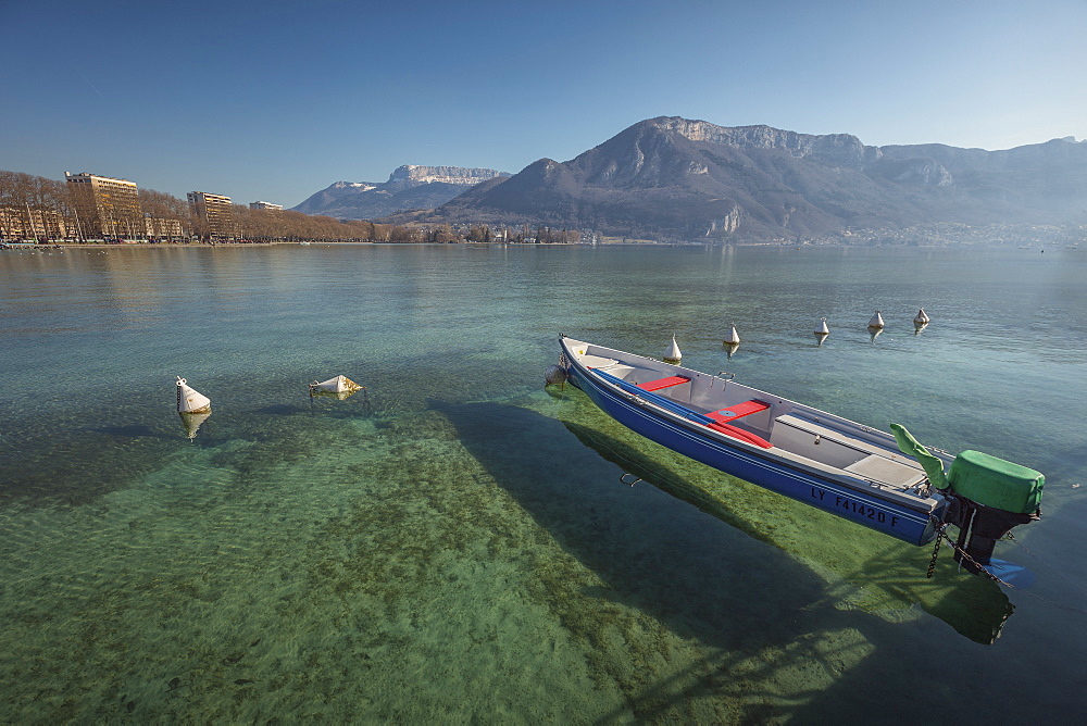 Tranquil scene with motorboat in lake, Annecy, Haute-Savoie, France