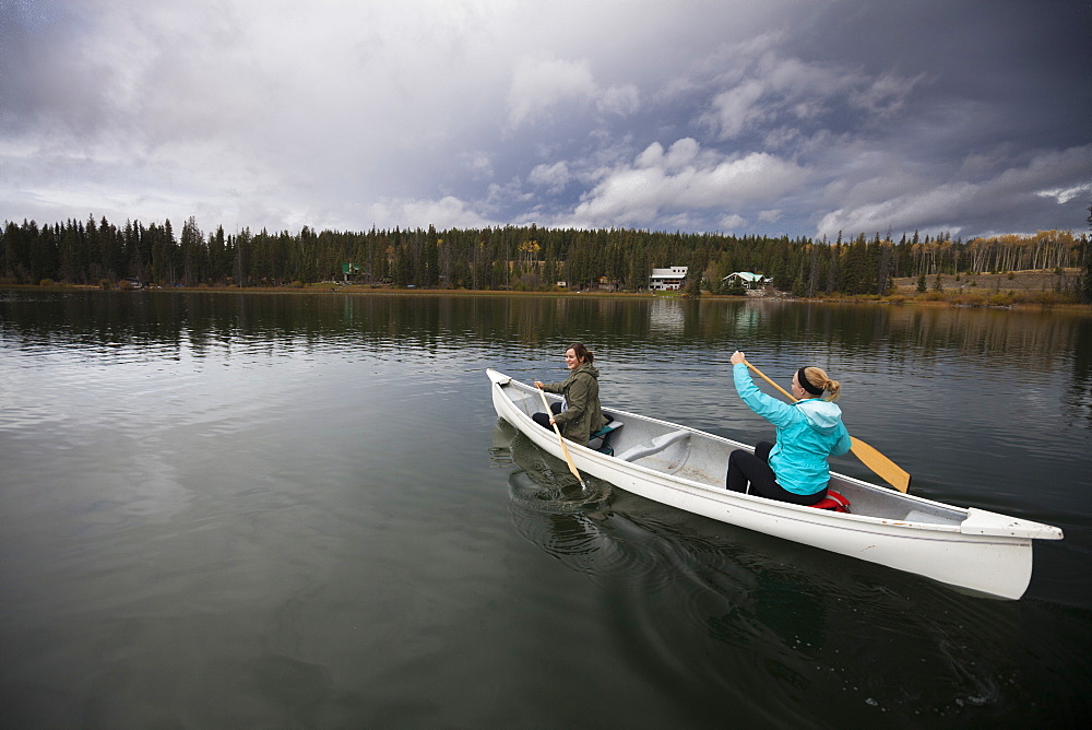 Two women canoeing on Lac Le Jeune, Kamloops, British Columbia, Canada