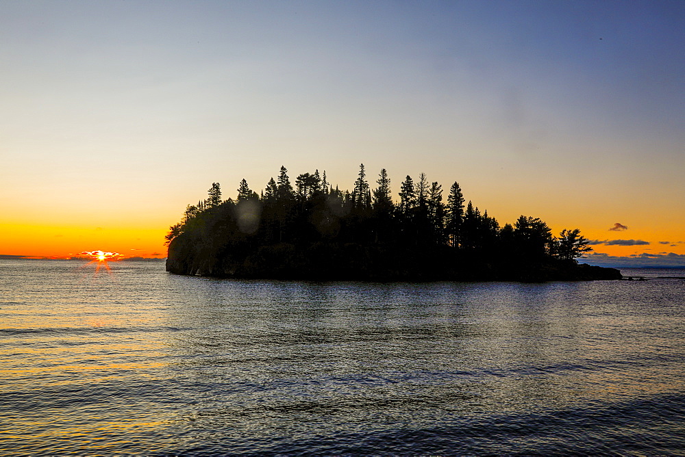 Beautiful scenery with silhouette of island with trees at sunset, Two Harbors, Minnesota, USA