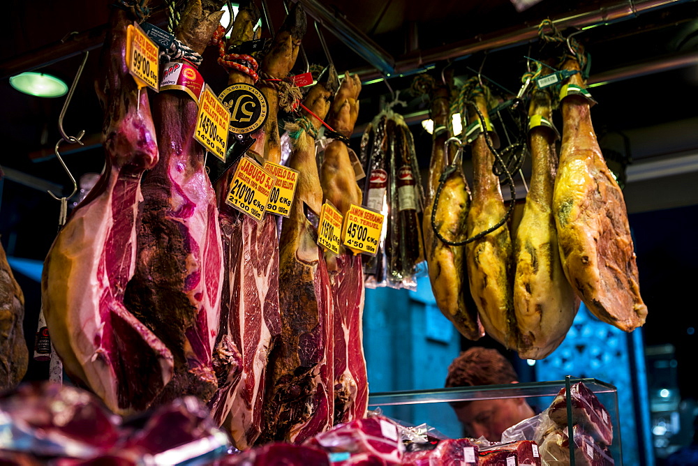 Various meat hanging in La Boqueria market in Barcelona, Spain