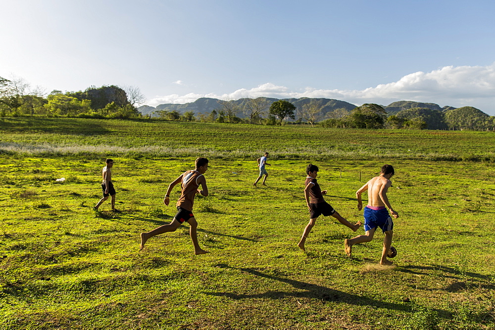 Group of children playing soccer in field, Vinales, Pinar del Rio Province, Cuba