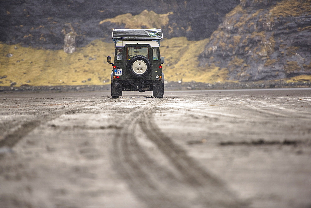 Rear view of 4x4 car in natural setting, Faroe Islands, Denmark