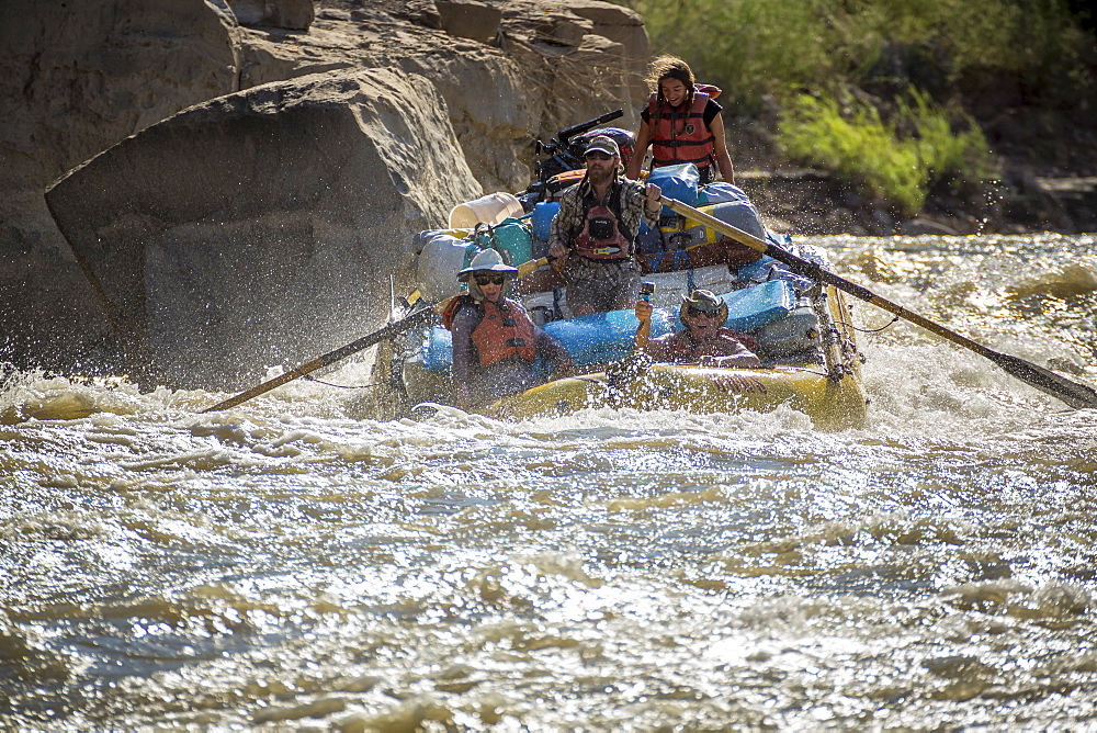 Men and women rafting on rushing Green River in Desolation Canyon, Utah, USA