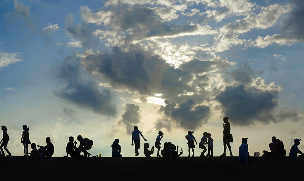 View of silhouettes of group of people against sky at sunset, Manila, Philippines