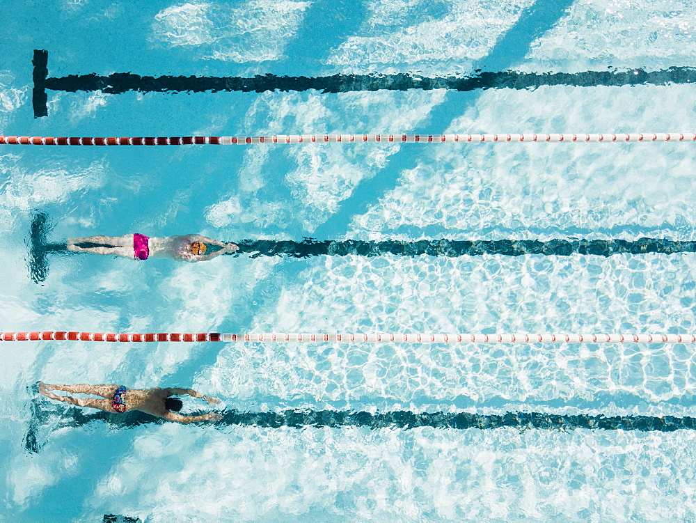 Aerial view of two swimmers in swimming pool, Mallorca, Balearic Islands, Spain