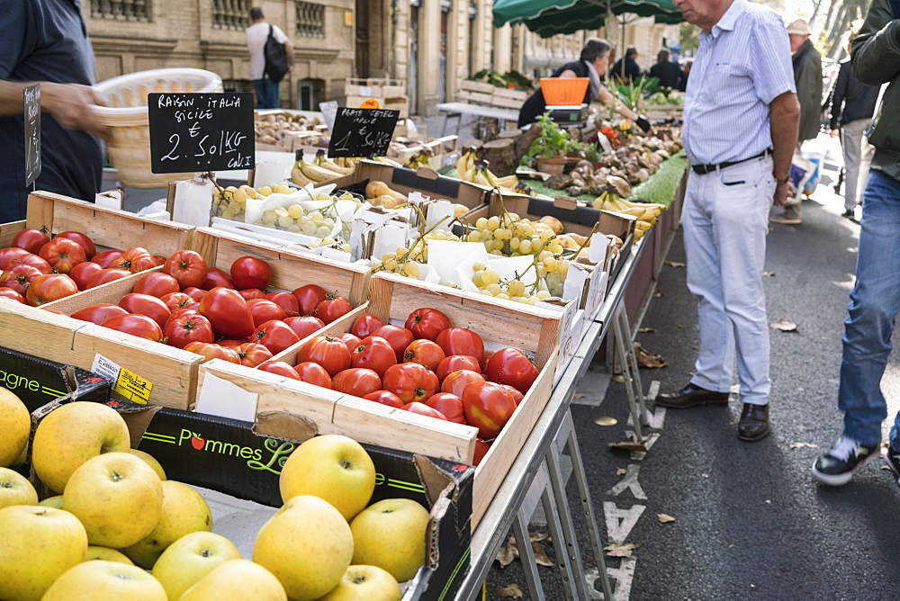 Apples, tomatoes and grapes in boxes at food street market, Toulouse, Occitanie, France