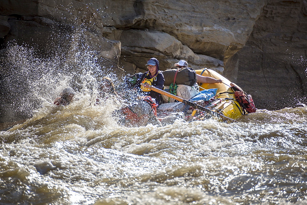 Men and women rafting on rushing Green River in Desolation Canyon, Utah, USA