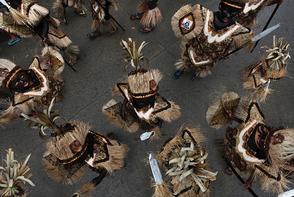 Children with black smeared faces in tribal costumes at Ati Atihan festival, Kalibo, Aklan, Panay Island, Philippines