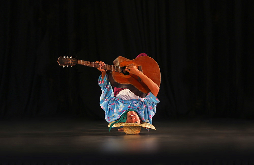 Guitar player upside down on stage, Villa Escudero, Manila, Luzon Island, Philippines