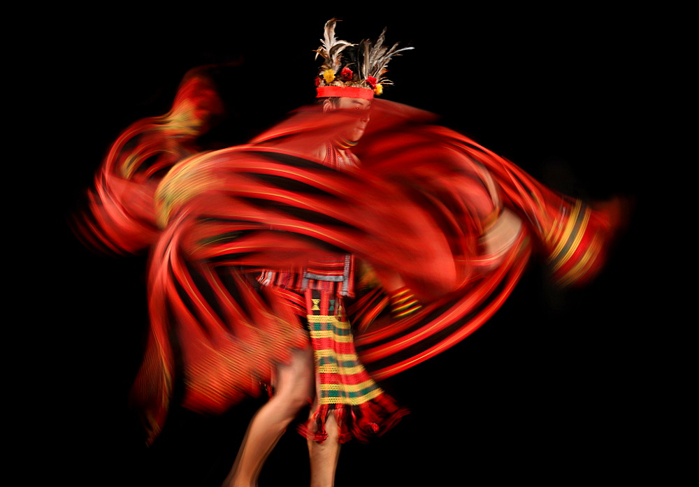 Ifugao tribesman dancing against black background, Banaue, Ifugao, Philippines