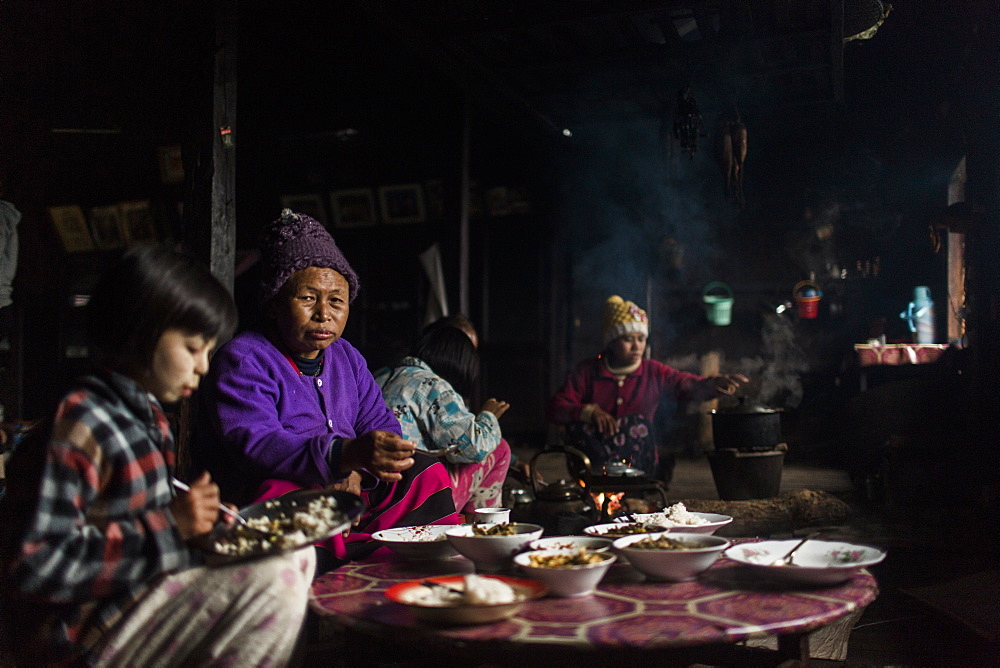 Three generation family eating together in small rural house, Myanmar, Shan, Myanmar