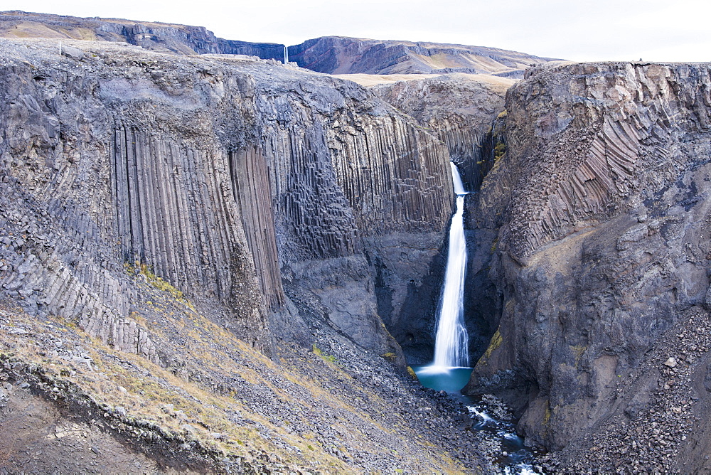 Scenic view of Litlanesfoss waterfall and surrounding cliffs of Hengifoss walking track, Iceland