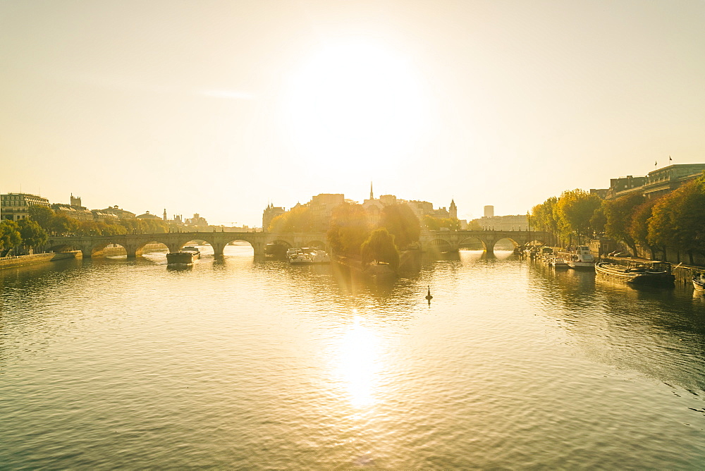 Sunrise on Seine River with Pont neuf or new bridge and isle de la cite where Notre Dame Cathedral is located, Paris, Ile-de-France, France