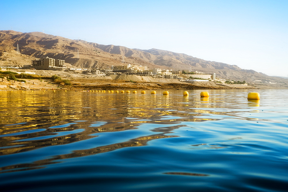 View from water of Dead Sea shoreline in Madaba Governorate, Jordan