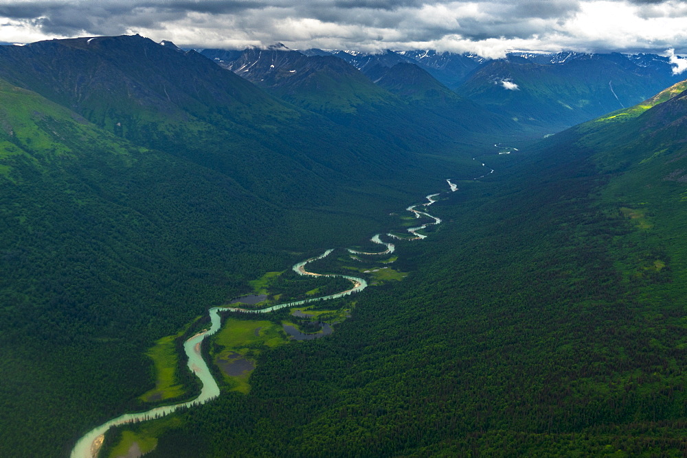 Majestic aerial view of natural scenery of Chugach Mountain range with glacier carved valley with river, Palmer, Alaska, USA