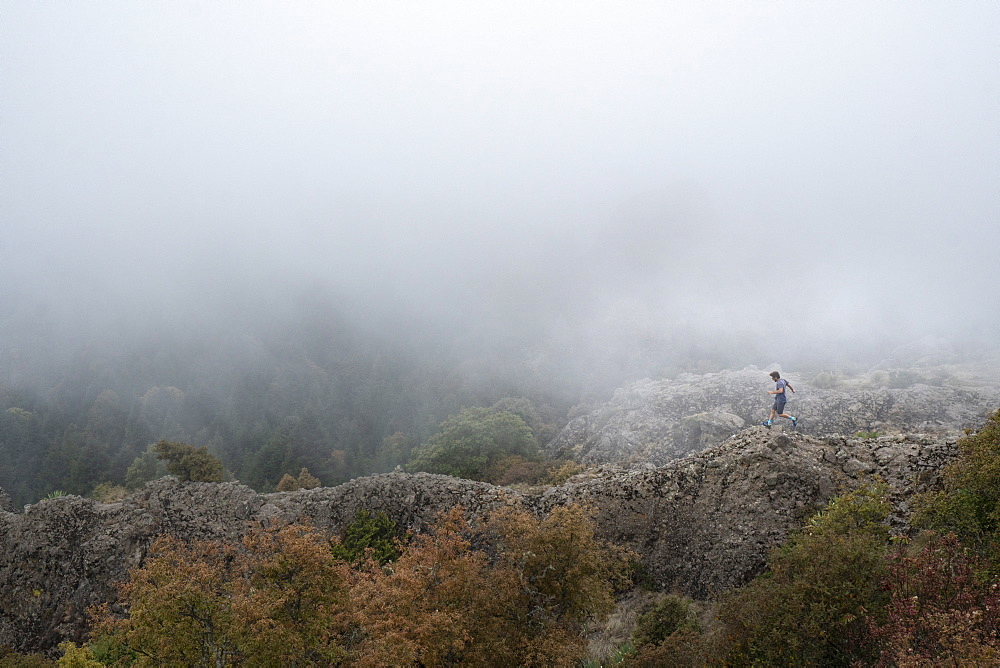 Man running on ridge inÂ El Chico National Park, Hidalgo, Mexico