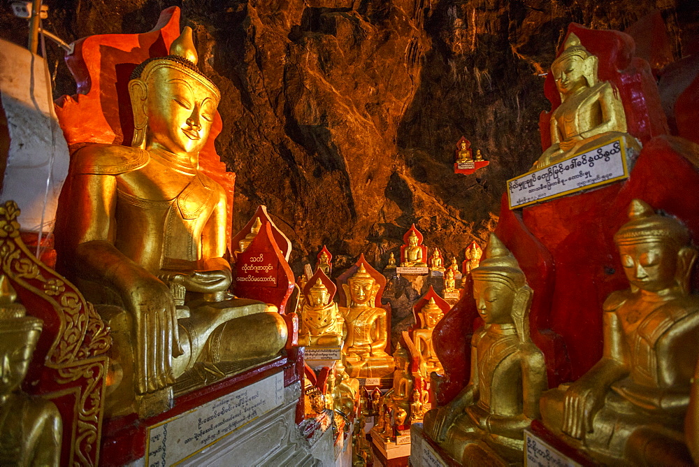 Gold Buddha statues line the sides of the famous Pindaya Caves in Shan State, Myanmar. The cave is a common tourist destination and pilgrimage site for Buddhists.