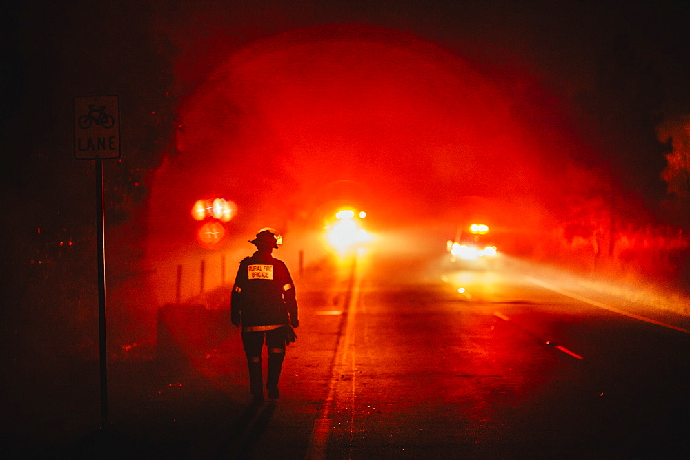 Firefighter walking the containment line, Pimpama, Queensland, Australia.
