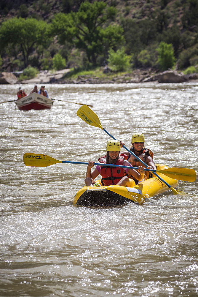 A young girl and her mother paddling an inflatable kayak, Green river rafting trip, Desolation/Gray Canyon section, Utah, USA