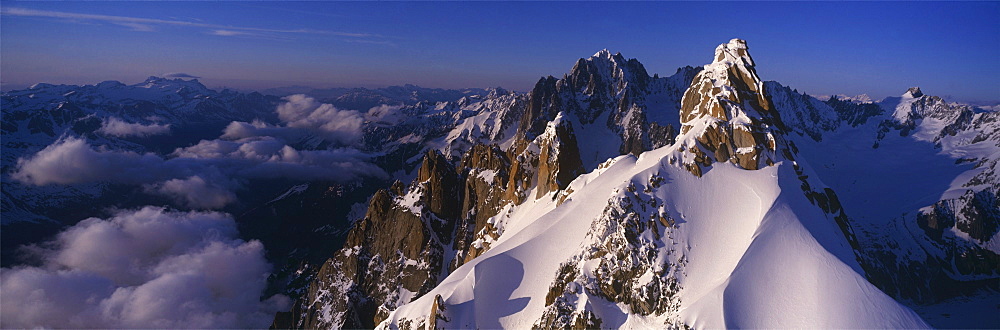 Panoramic of high mountain peaks in the Alps.