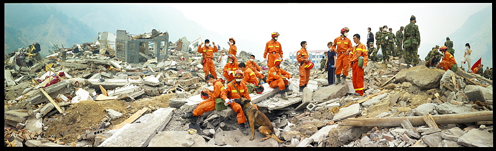 A rescue worker waters his dog  May 17 in Beichuan, China. The death toll in China's worst earthquake in 30 years could top 80, 000 according to the government.