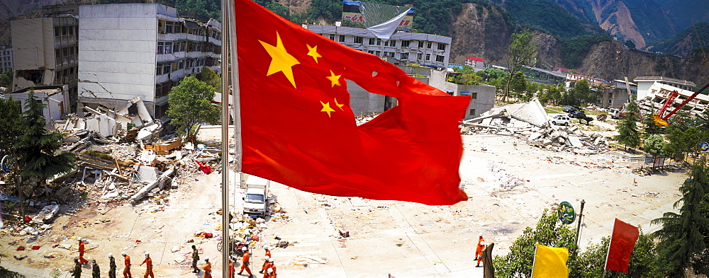 A damaged flad flies  May 17 in Beichuan, China. The death toll in China's worst earthquake in 30 years could top 80, 000 according to the government.