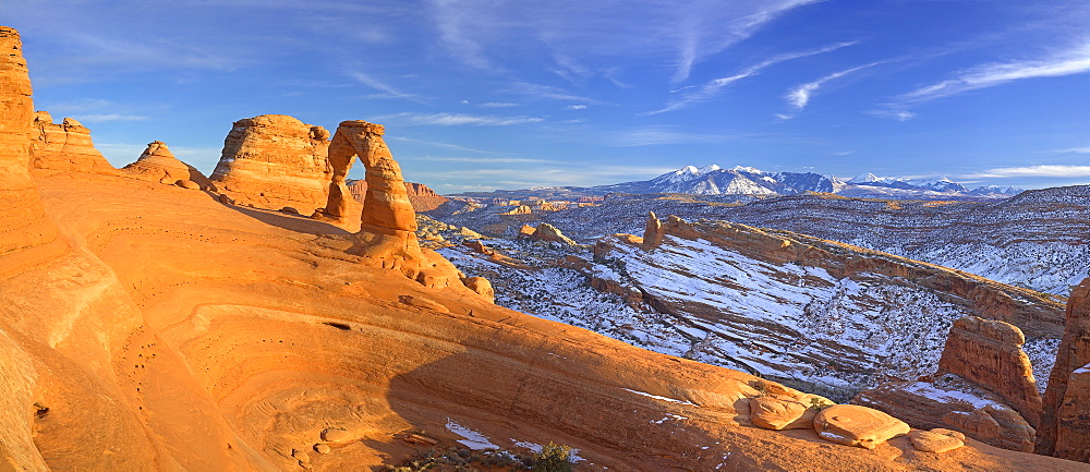 Delicate Arch glows as the sun sets over Arches National Park, Utah on December 26, 2006. The La Sal mountain range in the background has snowcapped peaks that tell of recent snowfall, United States of America