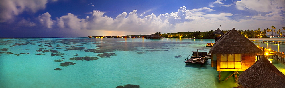 Panoramic view of over water villas under the moonlight at Gili Lankanfushi, in the Maldives