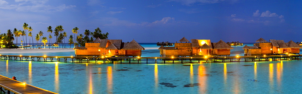 Aerial view of luxury tropical resort with stilt houses on Gili Lankanfushi island at night