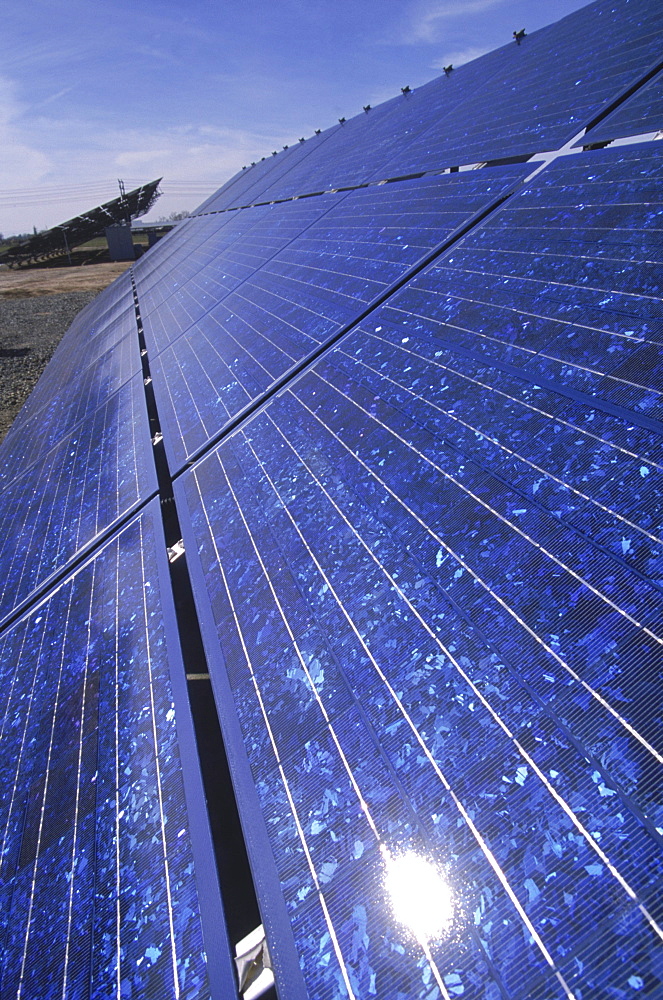 South of Sacramento, California, solar panels that follow the sun with the aid of mechanical timers, stretch across fields at the base of an older, abandoned energy site, a nuclear plant.