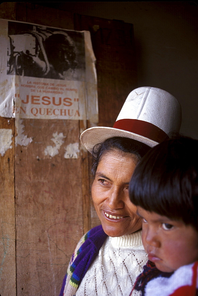 Peruvian Pentecostal convert Calixta Cruz stands with child in her doorway in Angostura. Cruz drew an abusive husband into the church after her conversion. This image is part of a five-part series on the rise of evangelical Protestantism in Latin America.