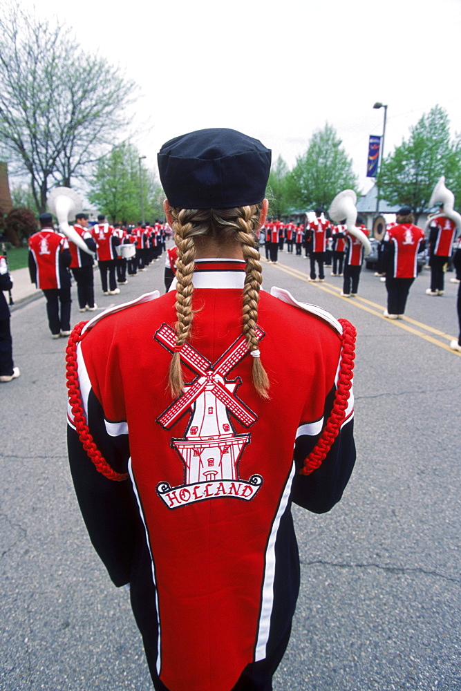 A windmill on the back of a marching band member in a parade during Tulip Festival in Holland, Michigan participating in the Meijer Muziekparade.