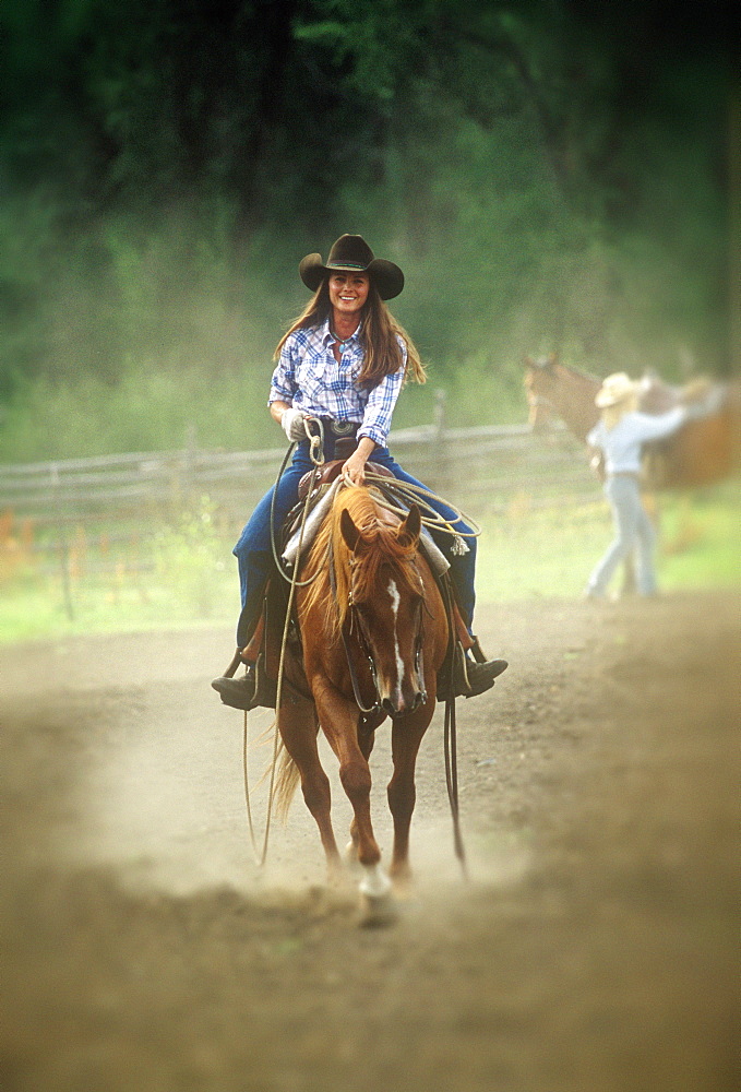 Brittain Roberts riding her horse in roping arena, Elkhead Ranch, Hayden, Colorado