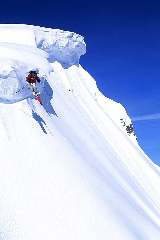 A skier catches air off a cornice at the Grand Targhee ski area, Alta, Wyoming.