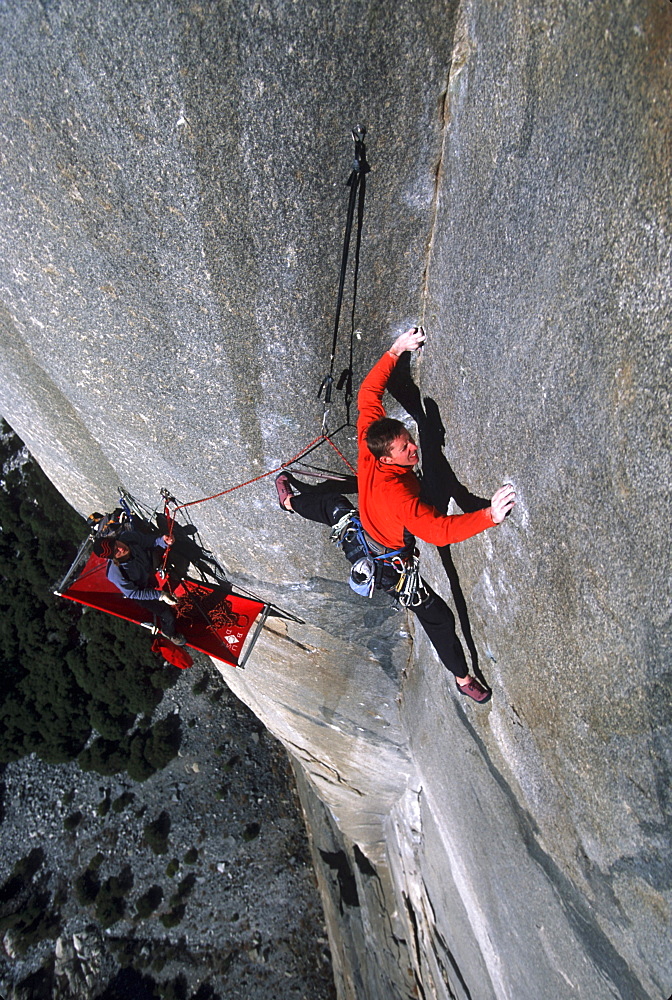 Tommy Caldwell doing the second free ascent of The Zodiac on El Capitan, Yosemite National Park, California. Caldwell is one of the worlds leading rock climbers. In the lower third Caldwell's climbing partner, Kevin Swift, is visible belaying while laying on his portaledge.