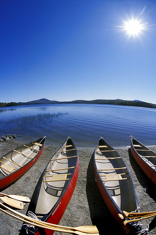 Canoes await their paddlers, Holeb Pond, Maine.