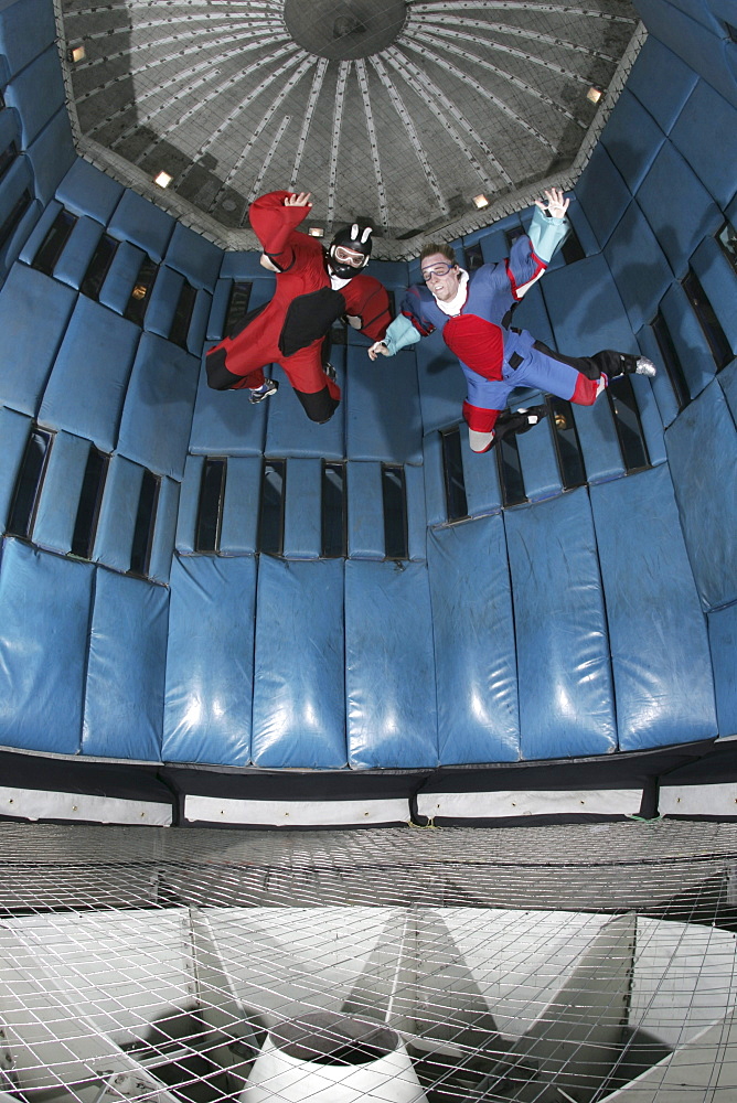 Two indoor skydiving instructors during a flight session in a wind tunnel that stimulates the freefall experience of skydiving, in Las Vegas, Nevada on April 15, 2005.