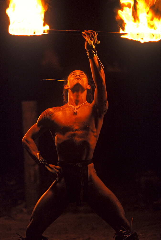 Traditional dancer with fire torch for tourists at Tiki Village,Moorea French Polynesia