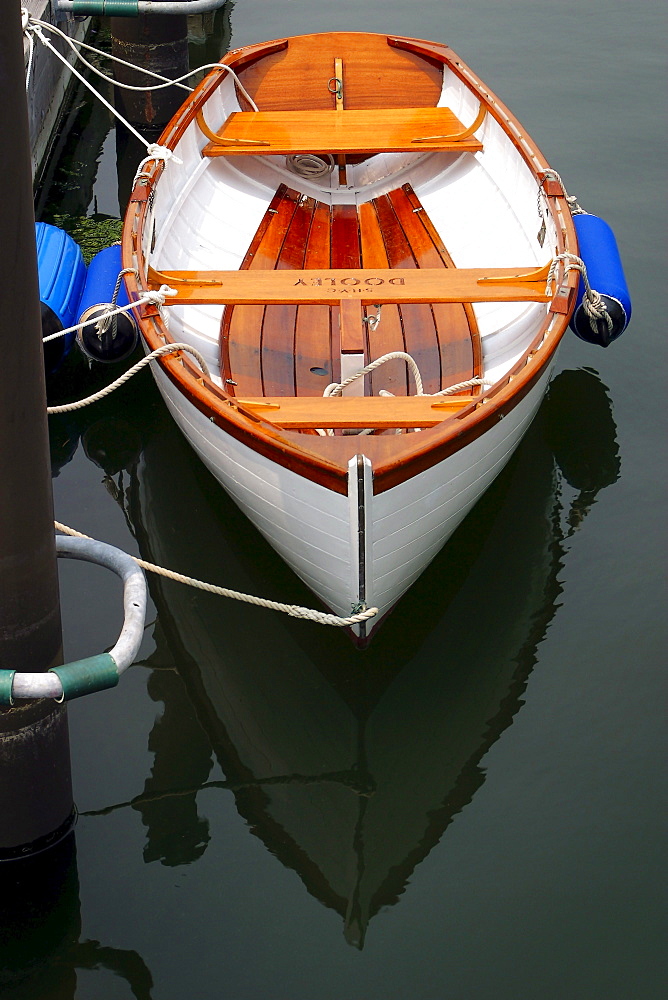 A row boat is tied to a dock.