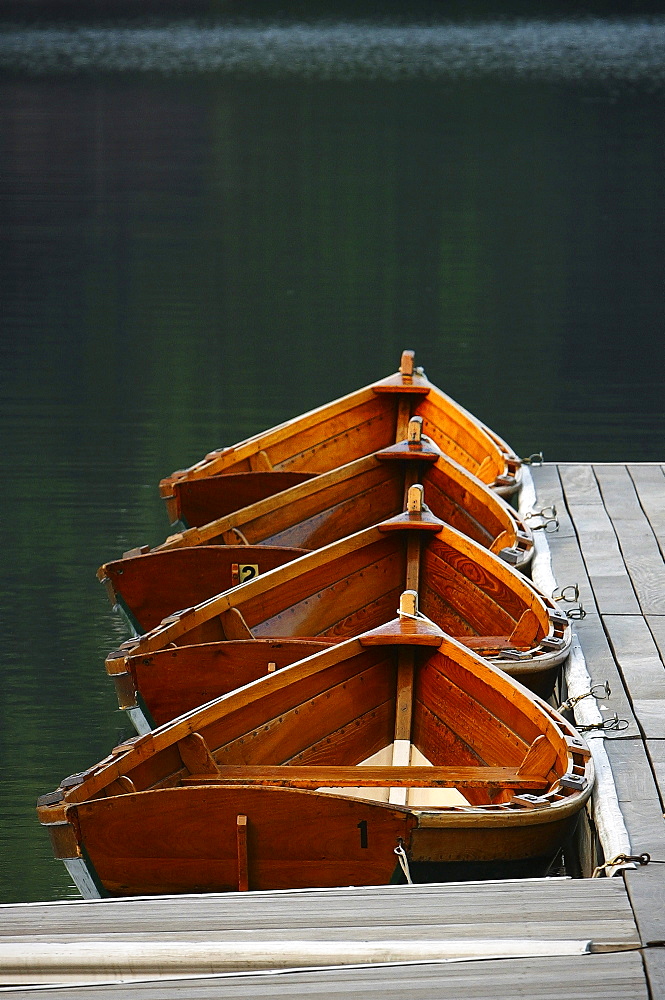 Four boats tied to the dock on Lake Mohonk, wait to be rowed.