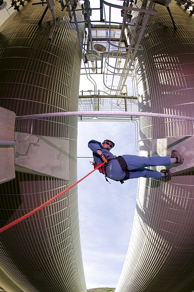 John Siekowski rappels among industrial propane tanks at a facility in Gaviota, California on March 29, 2004.  John is a member of the Santa Barbara County Search and Rescue. (Photo by Kevin Steele, Aurora)