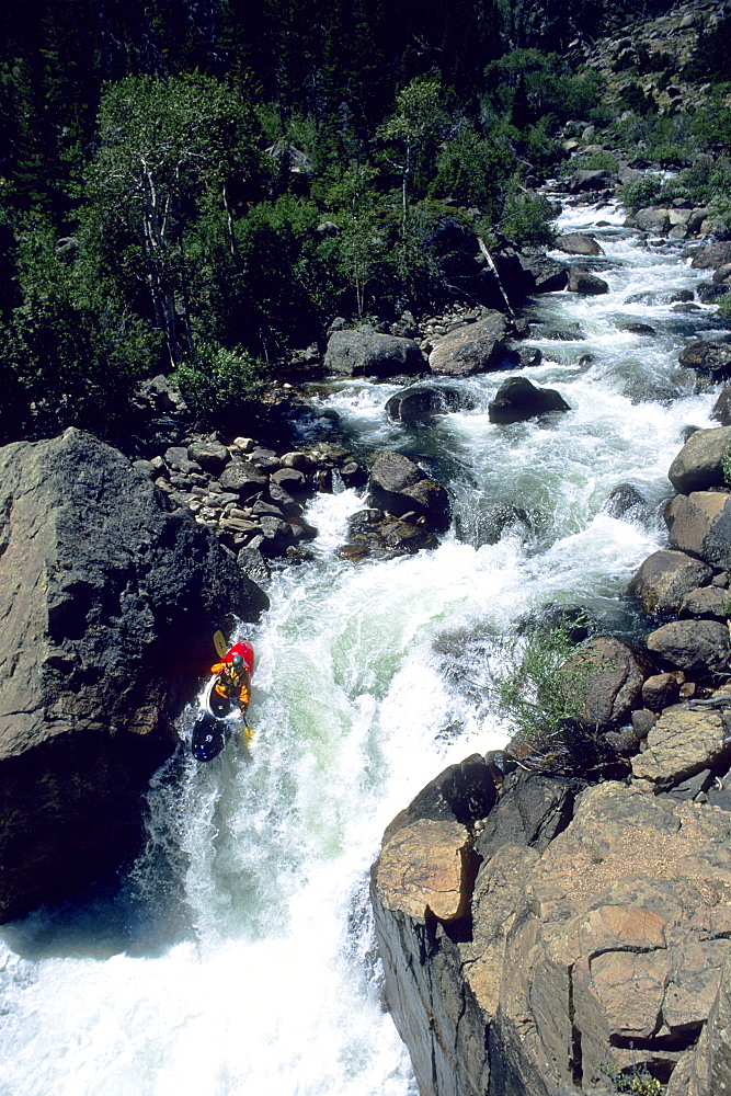 A whitwwater kayaker negotiates a Class V waterfall on the Popo Agie River, Lander, Wyoming. (Photo by Greg Von Doersten, Aurora)