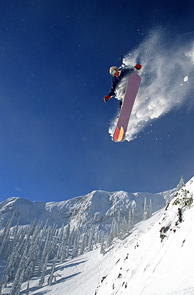 Young Snowboarder (Steve Whelan) catches big air at Fernie Alpine Resort, Fernie, East Kootenays, British Columbia, Canada.