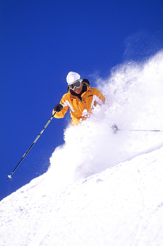 Heather Walker sking powder at Snowbird resort in Snowbird, Utah.