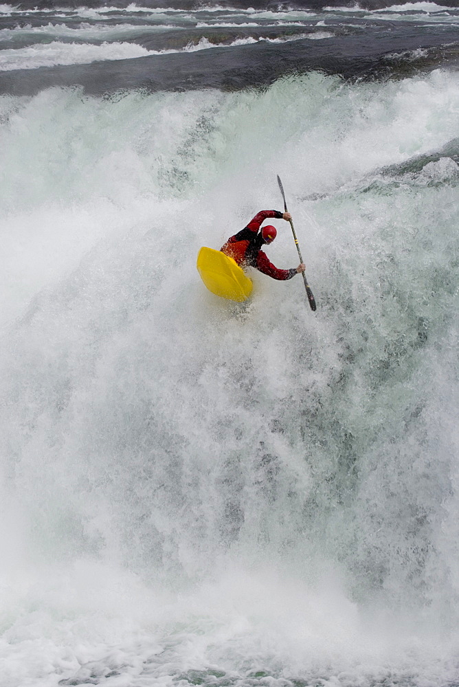 Young man (Trip Jennings) performs "freewheel" move over Kootenai Falls on Kootenai River near Libby, Montana