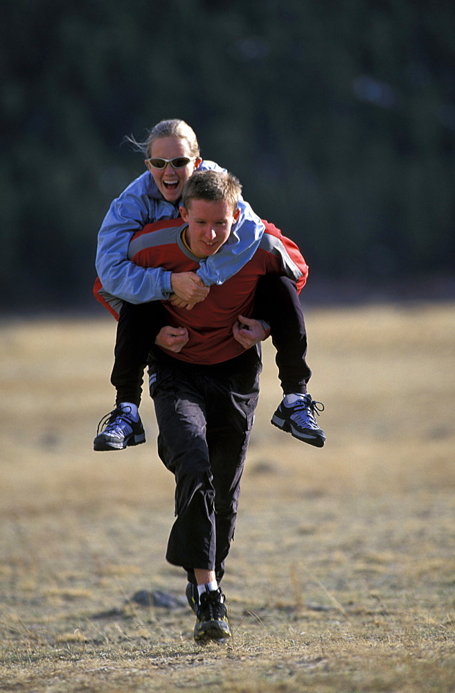 Beth Rodden and Tommy Caldwell get in some cross training with a piggy-back ride outside Estes Park, Colorado.