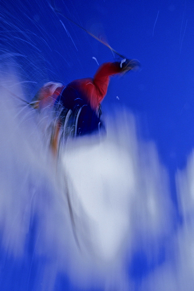 Telemark skier Jeremy Haas catches some big air off the cliffs at the top of Highlands Bowl, Highlands Ski Area, Aspen, CO. (motion blur)