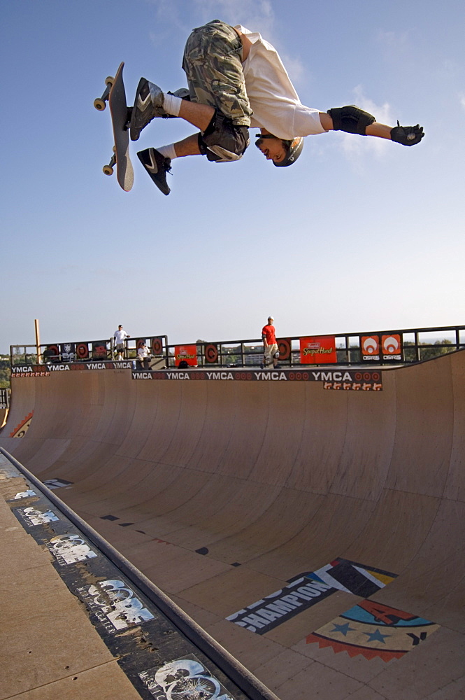 Pro skater Bob Burnquist practicing a trick on his skateboard shortly before a big competition in a skatepark in Encinitas. The skatepark was designed by legendary skateboarder Tony Hawk. California, USA.