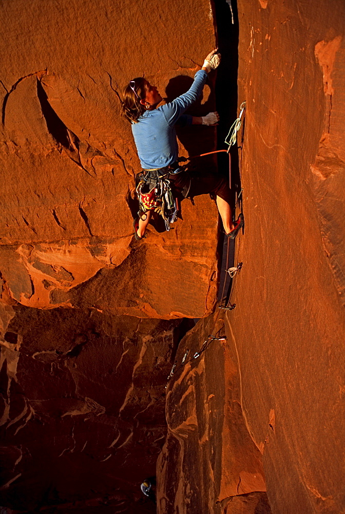 Katie Brown climbing the 'Window Route' 5.10+ on Echo Pinnacle, near Moab, Utah.